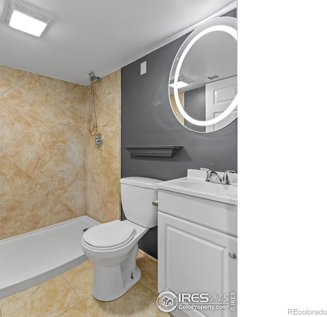18931 E Brunswick Pl, Aurora, CO 80013 - bathroom featuring a tile shower, vanity, and tile patterned flooring