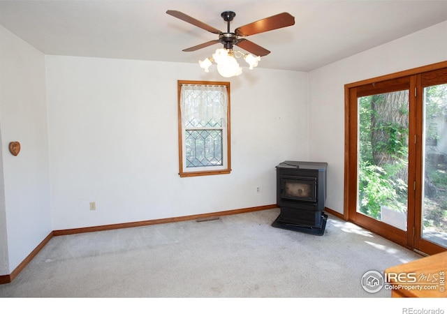 19089 Chambers Dr, Sterling, CO 80751 - unfurnished bedroom featuring a wood stove and carpet flooring