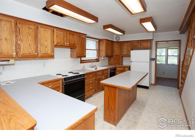 19089 Chambers Dr, Sterling, CO 80751 - kitchen featuring freestanding refrigerator, range with electric stovetop, and brown cabinets