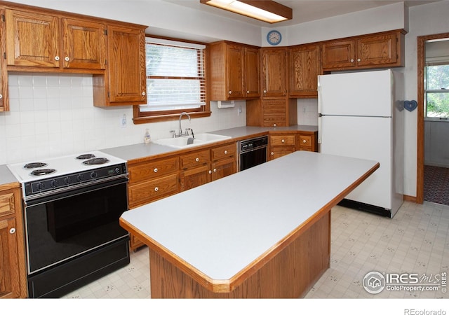 19089 Chambers Dr, Sterling, CO 80751 - kitchen featuring electric range, freestanding refrigerator, light flooring, and black dishwasher