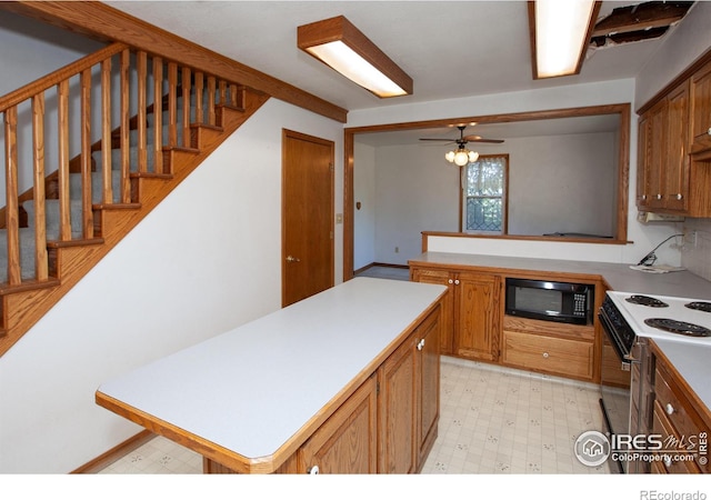 19089 Chambers Dr, Sterling, CO 80751 - kitchen featuring black microwave, white electric range oven, light countertops, and brown cabinets