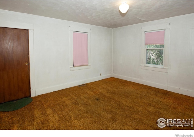 19089 Chambers Dr, Sterling, CO 80751 - carpeted empty room featuring a textured ceiling and baseboards