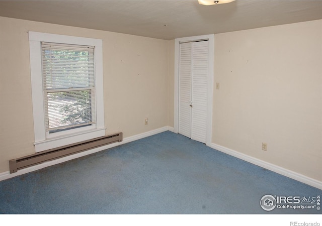 19089 Chambers Dr, Sterling, CO 80751 - unfurnished bedroom with a baseboard heating unit, carpet, and a closet