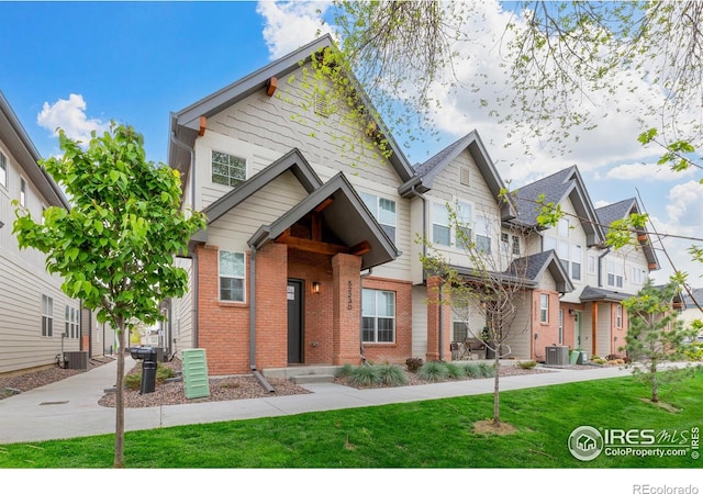5223 Allison Way Unit D, Arvada, CO 80002 - craftsman house featuring a front yard, brick siding, and a residential view