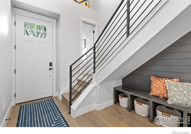 5223 Allison Way Unit D, Arvada, CO 80002 - entrance foyer featuring light wood finished floors, stairway, and wood walls