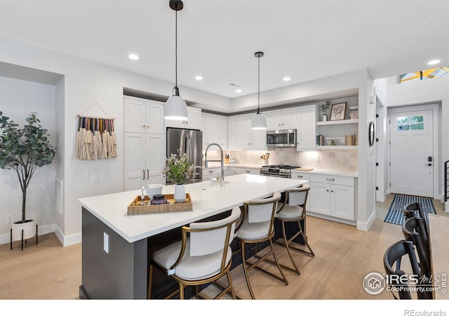 5223 Allison Way Unit D, Arvada, CO 80002 - kitchen with stainless steel appliances, light wood-style floors, white cabinetry, backsplash, and recessed lighting
