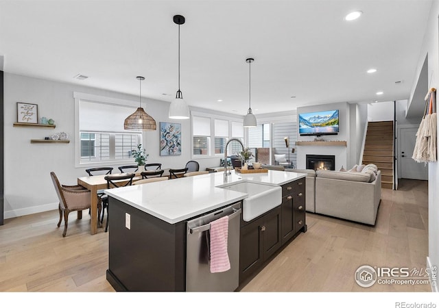 5223 Allison Way Unit D, Arvada, CO 80002 - kitchen with dishwasher, light wood finished floors, recessed lighting, a kitchen island with sink, and a glass covered fireplace