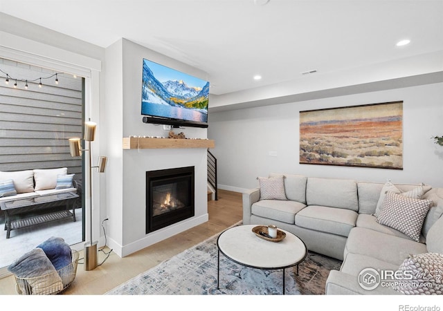 5223 Allison Way Unit D, Arvada, CO 80002 - living area featuring recessed lighting, light wood-style floors, and a glass covered fireplace