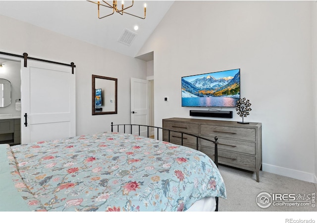 5223 Allison Way Unit D, Arvada, CO 80002 - bedroom with high vaulted ceiling, a barn door, a chandelier, carpet floors, and ensuite bath