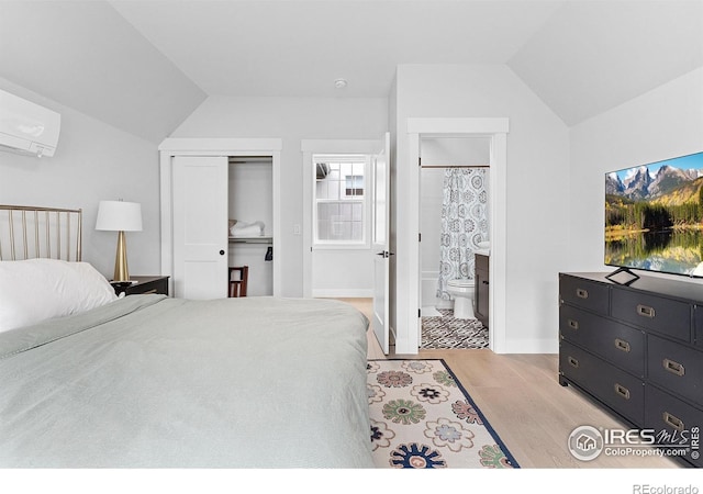 5223 Allison Way Unit D, Arvada, CO 80002 - bedroom with lofted ceiling, light wood-style flooring, a wall mounted AC, a closet, and ensuite bathroom