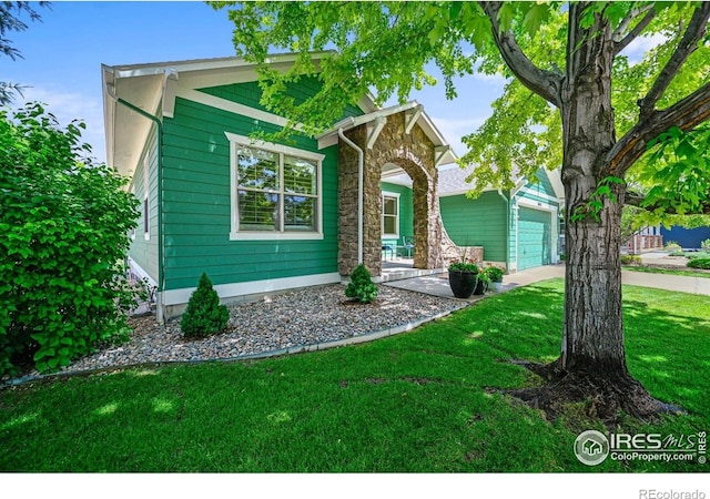 3031 Thunder Lake Cir, Lafayette, CO 80026 - view of front of property with a garage, driveway, a front yard, a porch, and stone siding