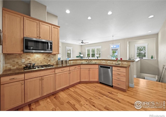 3031 Thunder Lake Cir, Lafayette, CO 80026 - kitchen featuring stainless steel appliances, light wood-type flooring, recessed lighting, light brown cabinets, and backsplash