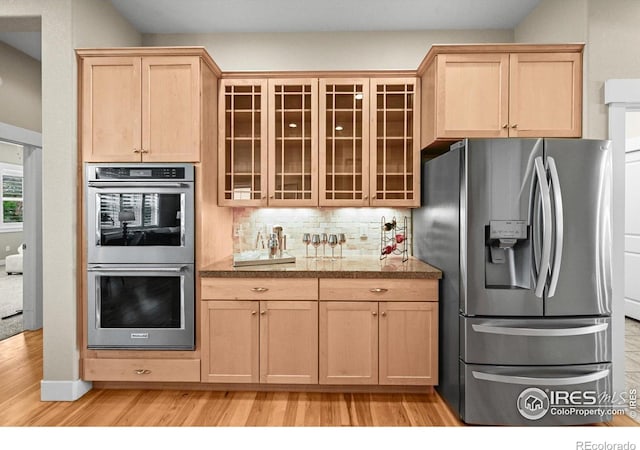 3031 Thunder Lake Cir, Lafayette, CO 80026 - kitchen featuring appliances with stainless steel finishes, light brown cabinets, light wood-type flooring, glass insert cabinets, and tile counters