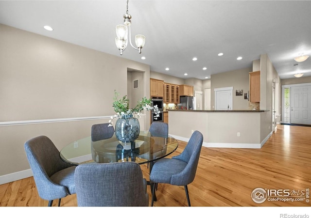 3031 Thunder Lake Cir, Lafayette, CO 80026 - dining area with light wood-type flooring, a chandelier, and recessed lighting