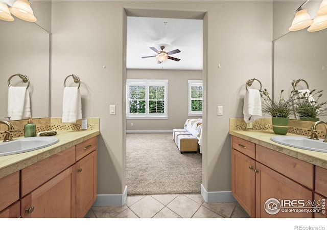 3031 Thunder Lake Cir, Lafayette, CO 80026 - full bathroom with two vanities, a ceiling fan, tile patterned floors, and backsplash
