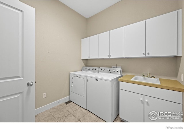 3031 Thunder Lake Cir, Lafayette, CO 80026 - laundry room with cabinet space, washer and dryer, and light tile patterned floors