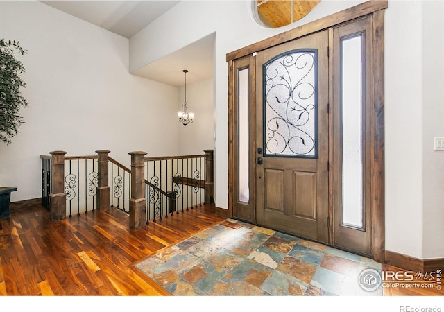 973 Skipping Stone Ct, Timnath, CO 80547 - foyer entrance featuring a chandelier, wood finished floors, and healthy amount of natural light