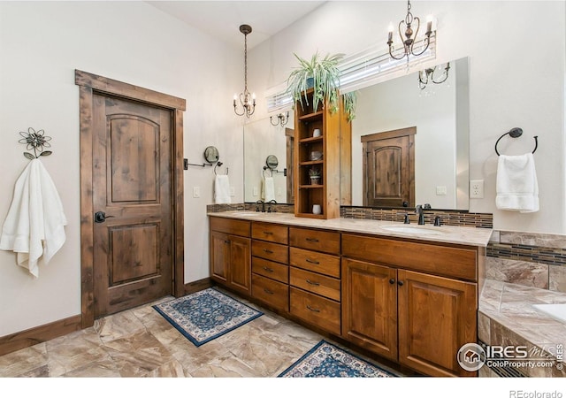 973 Skipping Stone Ct, Timnath, CO 80547 - bathroom with a chandelier, double vanity, marble look tile flooring, and a bath