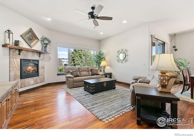 973 Skipping Stone Ct, Timnath, CO 80547 - living room featuring ceiling fan, wood finished floors, a fireplace, and recessed lighting