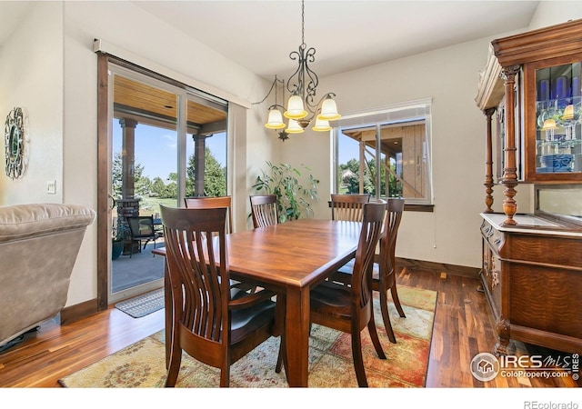 973 Skipping Stone Ct, Timnath, CO 80547 - dining space with a chandelier and wood finished floors