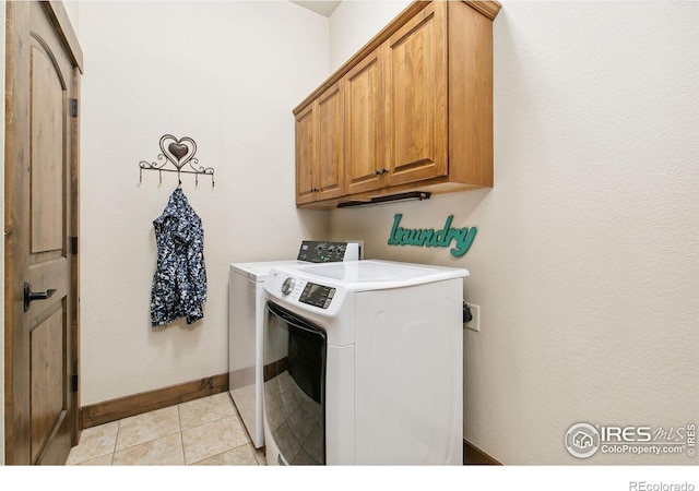 973 Skipping Stone Ct, Timnath, CO 80547 - laundry room featuring cabinet space, washing machine and clothes dryer, and light tile patterned floors