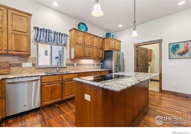 973 Skipping Stone Ct, Timnath, CO 80547 - kitchen featuring stainless steel appliances, dark wood-type flooring, decorative backsplash, brown cabinets, and recessed lighting