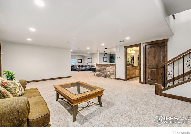 973 Skipping Stone Ct, Timnath, CO 80547 - living area featuring light colored carpet, stairway, and recessed lighting
