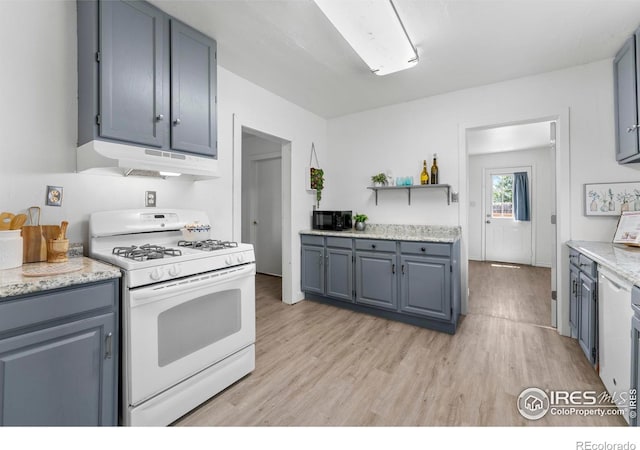 114 Berwick Ave, Firestone, CO 80520 - kitchen featuring gas range gas stove, under cabinet range hood, black microwave, and light wood-type flooring