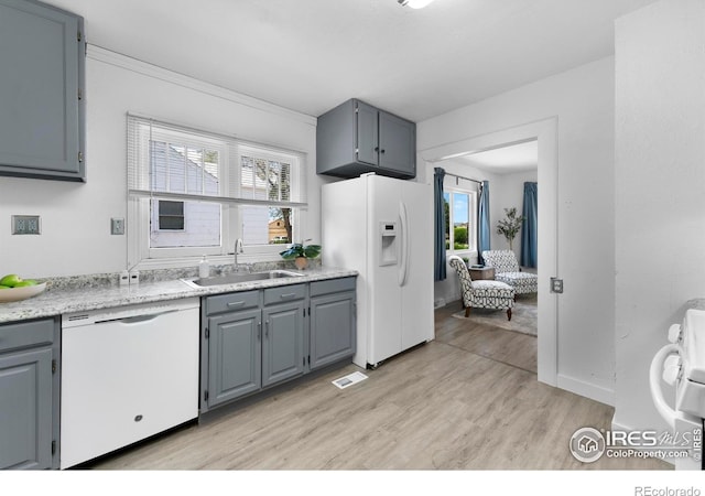 114 Berwick Ave, Firestone, CO 80520 - kitchen with white appliances, light wood-type flooring, light countertops, and gray cabinets
