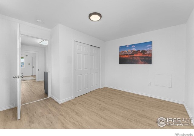 114 Berwick Ave, Firestone, CO 80520 - unfurnished bedroom with light wood finished floors and a closet
