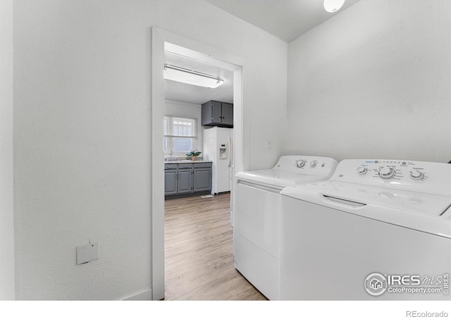 114 Berwick Ave, Firestone, CO 80520 - laundry area with washing machine and dryer and light wood-style flooring