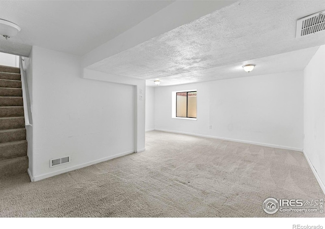 114 Berwick Ave, Firestone, CO 80520 - below grade area featuring stairway, carpet floors, and a textured ceiling