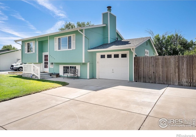 3066 W 134th Ct, Broomfield, CO 80020 - raised ranch with an attached garage, a chimney, and driveway