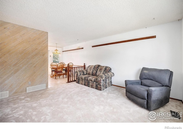 3066 W 134th Ct, Broomfield, CO 80020 - living room featuring wooden walls, a textured ceiling, and carpet flooring