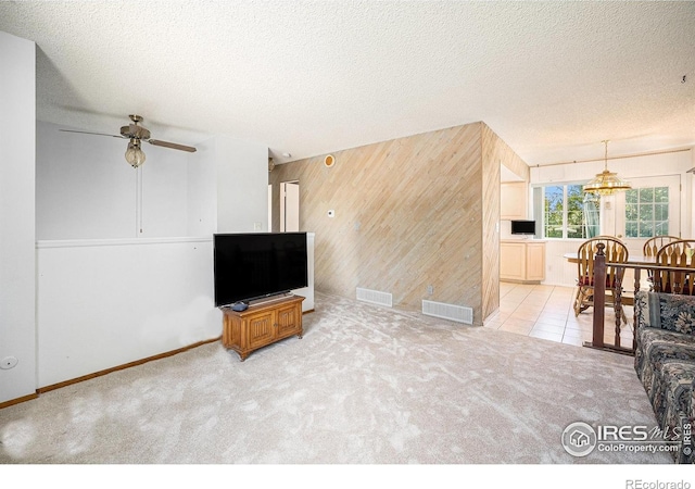 3066 W 134th Ct, Broomfield, CO 80020 - living room with wooden walls, carpet floors, a ceiling fan, a textured ceiling, and an accent wall