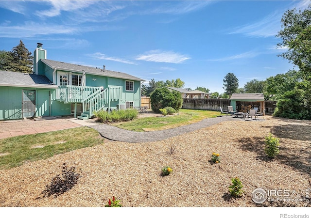 3066 W 134th Ct, Broomfield, CO 80020 - back of house with a patio, a fenced backyard, an outdoor fire pit, and a deck