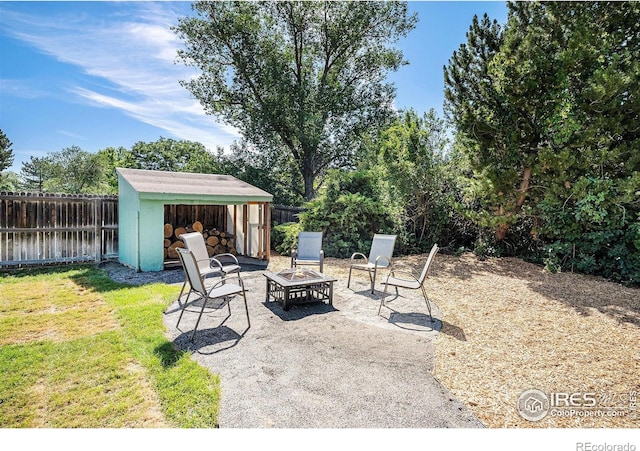 3066 W 134th Ct, Broomfield, CO 80020 - fenced backyard with an outdoor fire pit, a storage shed, and a patio area