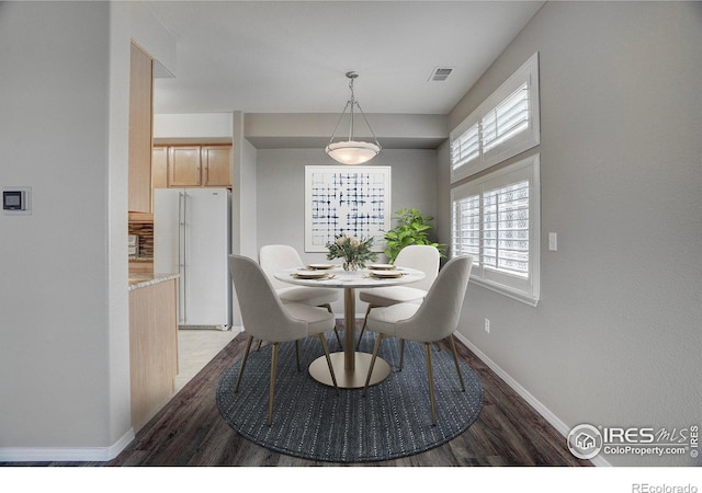 9266 W 107th Ln, Broomfield, CO 80021 - dining area featuring baseboards and dark wood-style floors