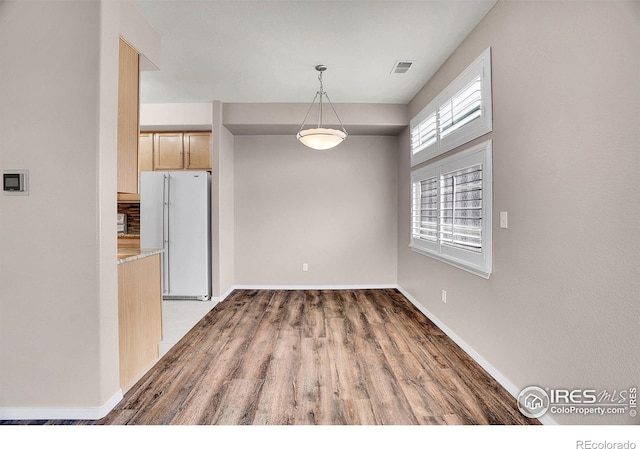 9266 W 107th Ln, Broomfield, CO 80021 - unfurnished dining area featuring wood finished floors and baseboards