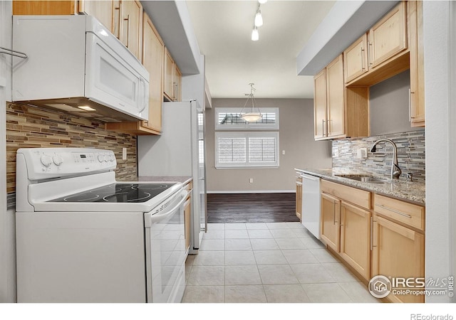 9266 W 107th Ln, Broomfield, CO 80021 - kitchen with white appliances, light brown cabinets, light tile patterned floors, and decorative backsplash