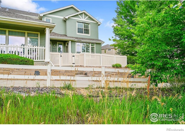 9266 W 107th Ln, Broomfield, CO 80021 - view of front facade featuring a garden and a shingled roof