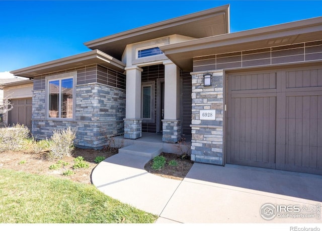 6928 Summerwind Ct, Timnath, CO 80547 - property entrance with stone siding, an attached garage, and a porch