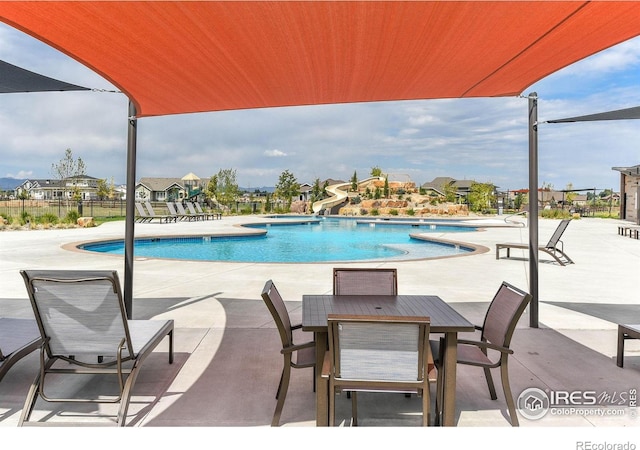 6928 Summerwind Ct, Timnath, CO 80547 - community pool featuring a water slide and a patio area