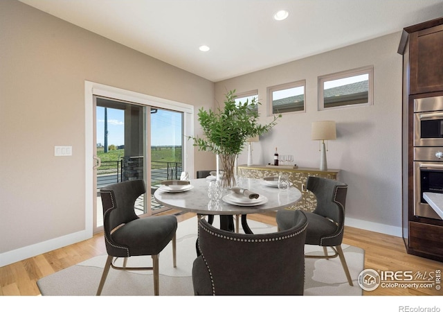 6928 Summerwind Ct, Timnath, CO 80547 - dining space featuring light wood-style floors and recessed lighting