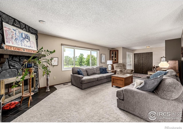14 Douglas Dr N, Broomfield, CO 80020 - living area featuring a textured ceiling, a stone fireplace, and carpet flooring