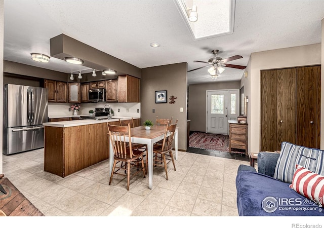 14 Douglas Dr N, Broomfield, CO 80020 - dining area featuring ceiling fan, a skylight, and a textured ceiling