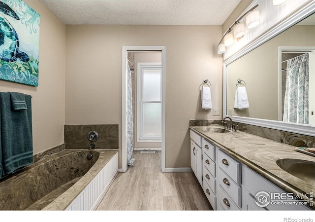 14 Douglas Dr N, Broomfield, CO 80020 - full bathroom with double vanity, wood finished floors, a garden tub, a textured ceiling, and curtained shower