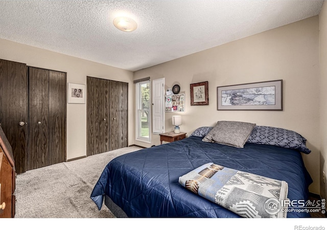 14 Douglas Dr N, Broomfield, CO 80020 - carpeted bedroom featuring two closets and a textured ceiling
