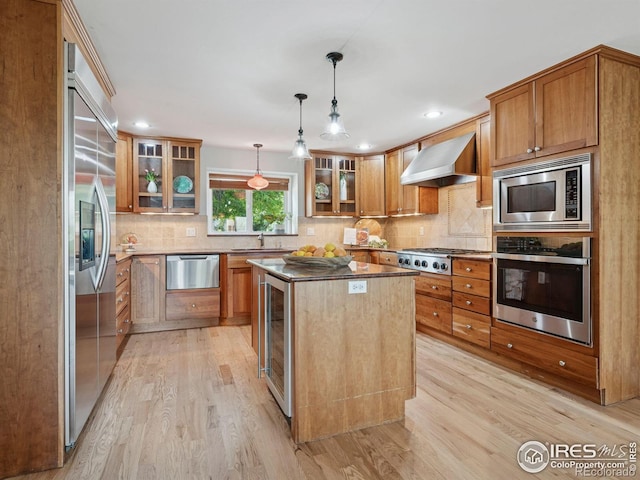 2695 Stanford Ave, Boulder, CO 80305 - kitchen with built in appliances, wall chimney range hood, light wood-style flooring, beverage cooler, and brown cabinets