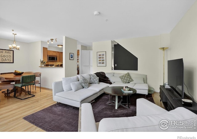 2954 Kalmia Ave # 34, Boulder, CO 80301 - living room featuring light wood-style flooring and a chandelier